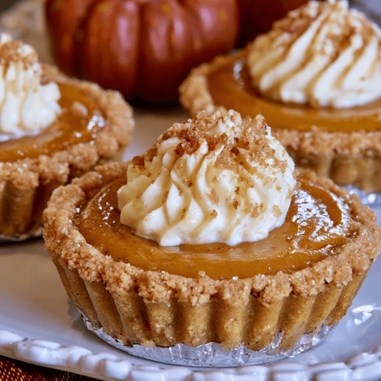 Mini air fryer pumpkin tarts with creamy pumpkin filling on a serving tray