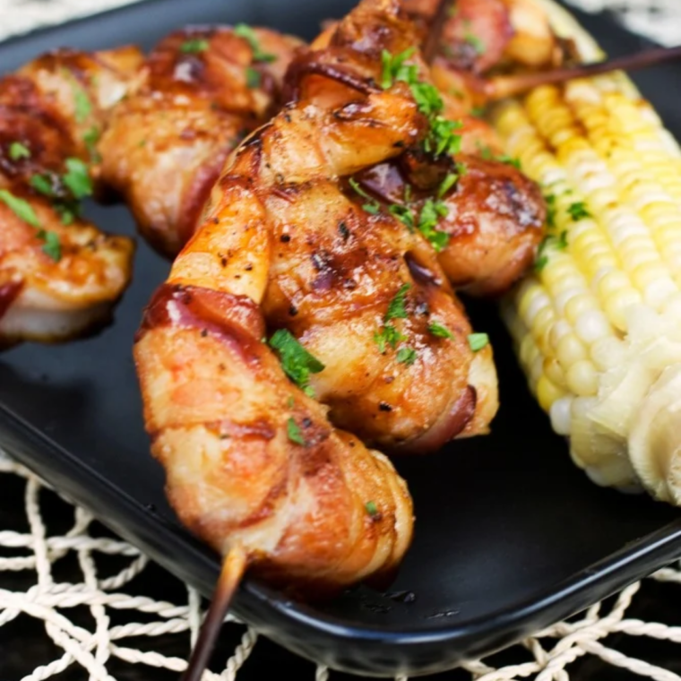 Spicy Cajun shrimp marinade coating grilled shrimp with lemon wedges and fresh parsley