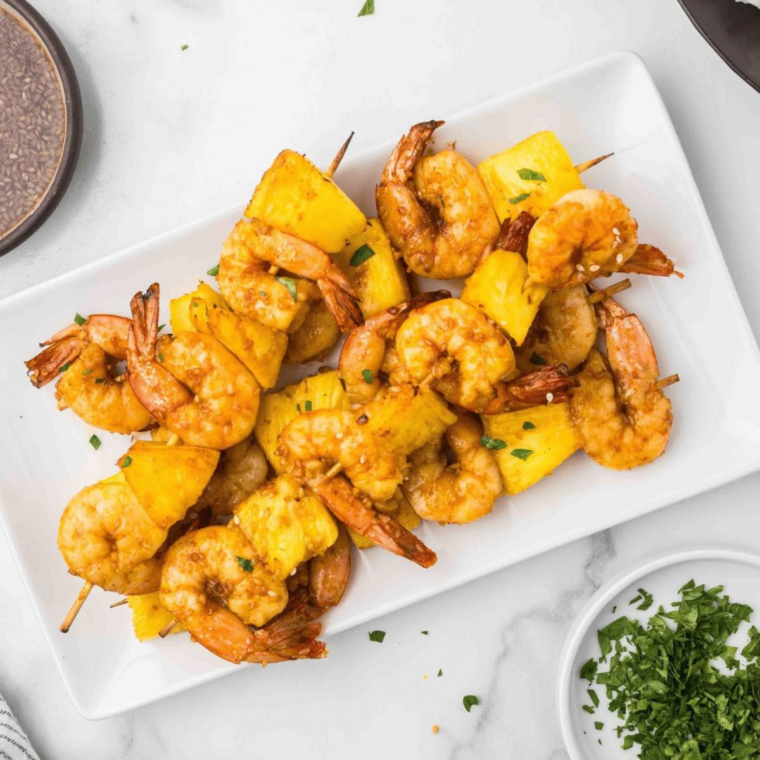 Hawaiian pineapple-teriyaki shrimp kabobs with grilled pineapple chunks, bell peppers, and red onion