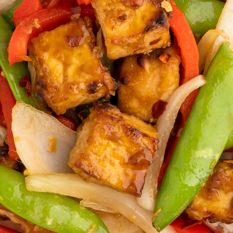 Classic soy-ginger garlic tofu marinade in a bowl with crispy marinated tofu cubes, sesame seeds and green onions