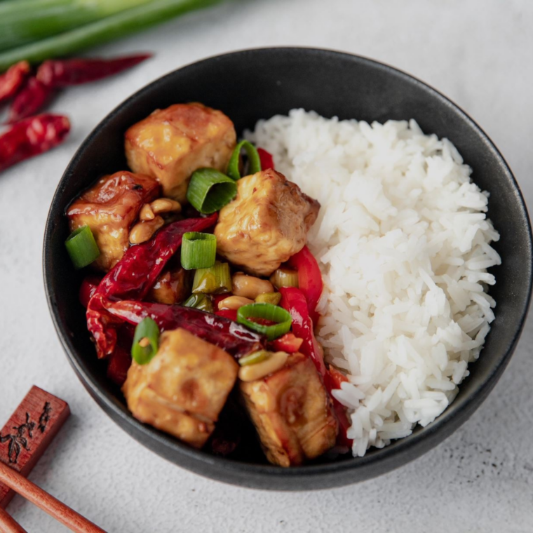 Honey teriyaki tofu marinade cooked into a glossy glaze on crispy tofu cubes topped with sesame seeds