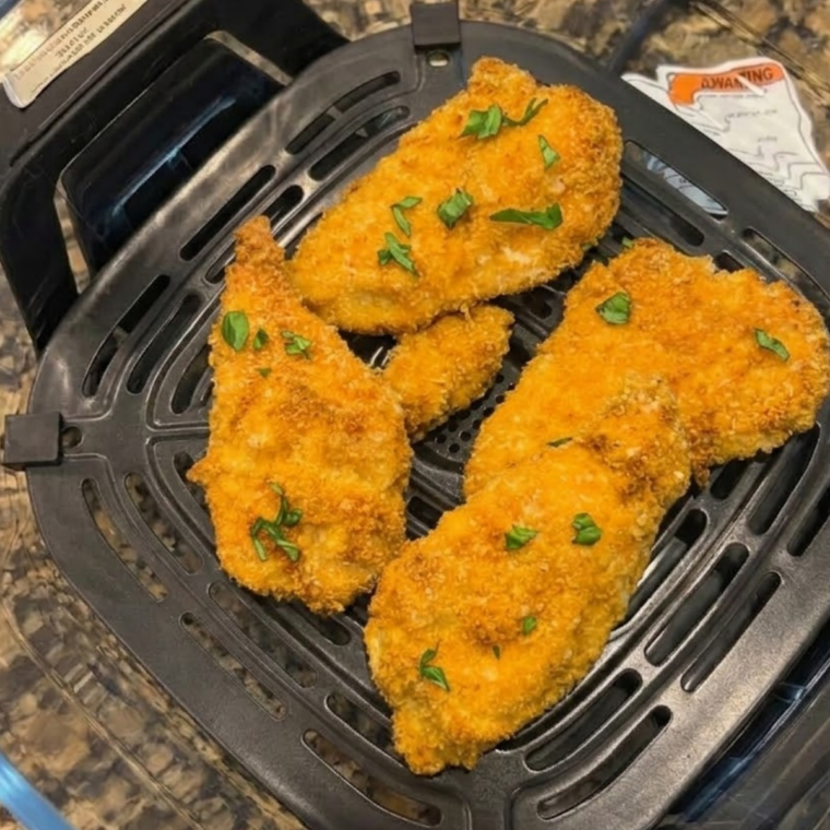 Golden breaded chicken cutlets cooked in a Ninja Crispi glass container with a crunchy panko crust