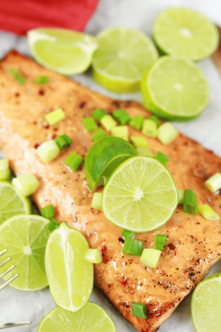 Seasoned salmon fillet with golden crisp skin cooked in a Ninja Crispi, served over rice with fresh herbs