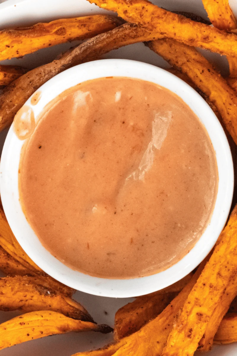 Chick-fil-A Honey Roasted BBQ Sauce copycat in a small bowl on a plate with crispy sweet potato fries