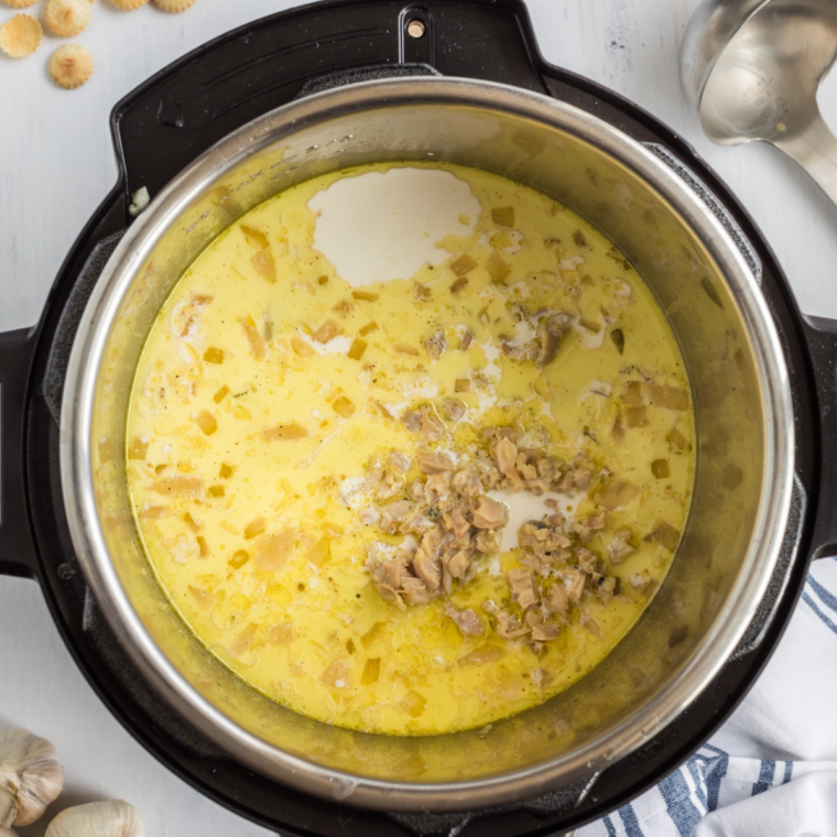 Stirring chopped clams into creamy chowder