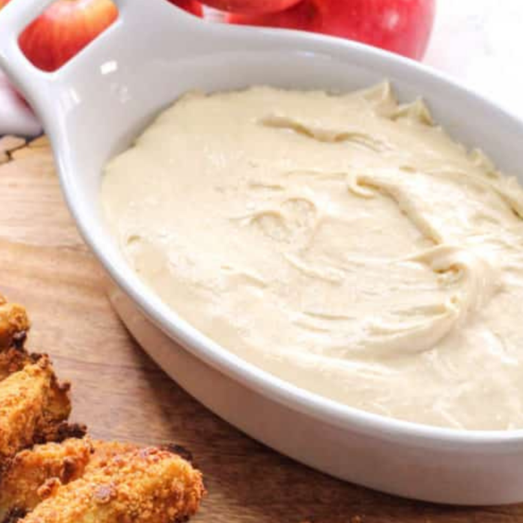 Smooth copycat Auntie Anne's cream cheese dip scooped into a small serving bowl