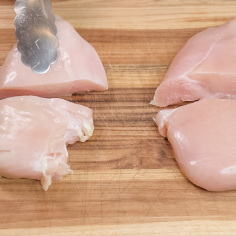 Chicken breast cutlets pounded to an even thickness under plastic wrap with a meat mallet