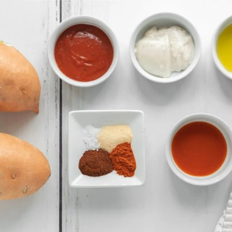 Ingredients for copycat honey roasted BBQ sauce: mayonnaise, honey, yellow mustard, apple cider vinegar, tomato paste, and smoked paprika in small bowls