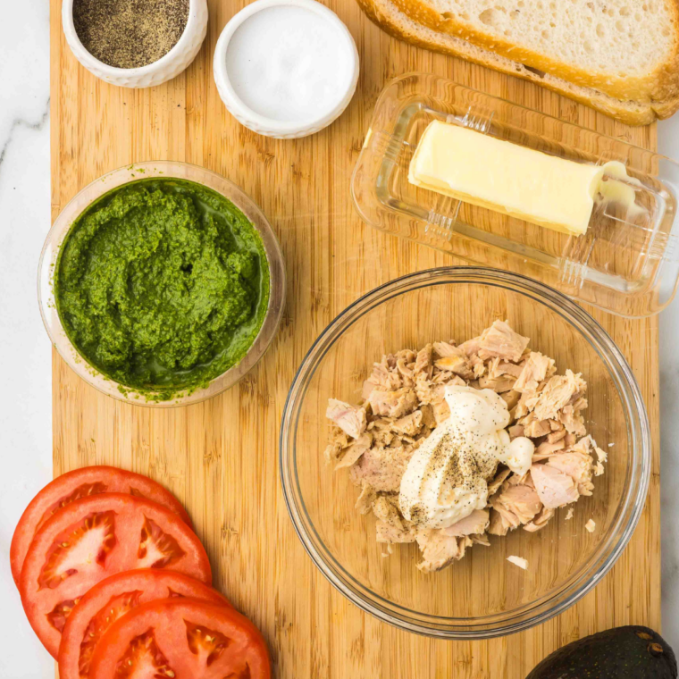 Mixing tuna, mayo, celery, onion, and soy sauce together in a glass bowl