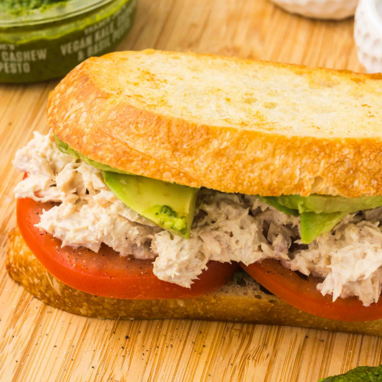 Copycat Jimmy John's tuna sandwich on a French roll with tuna salad, cucumber, tomato, and shredded lettuce