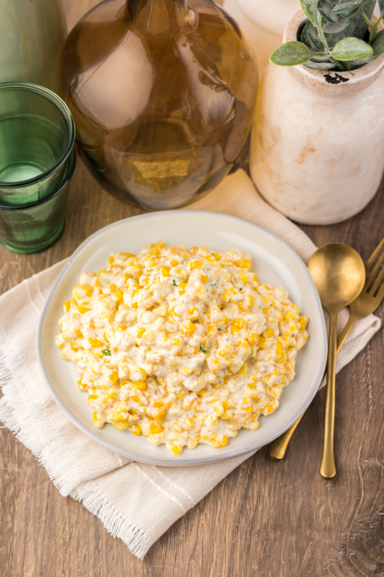 Finished Lawry's creamed corn recipe in a white serving dish, ready for a holiday dinner.
