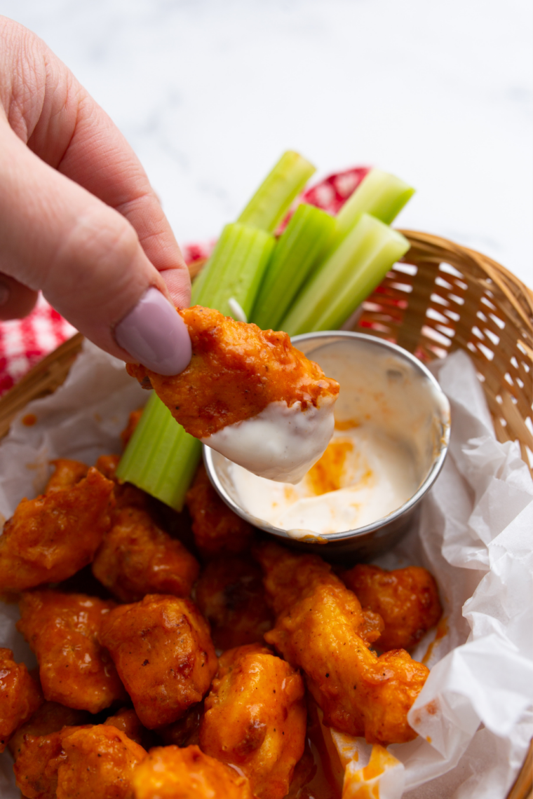 Plate of copycat Pizza Hut boneless wings tossed in buffalo sauce.