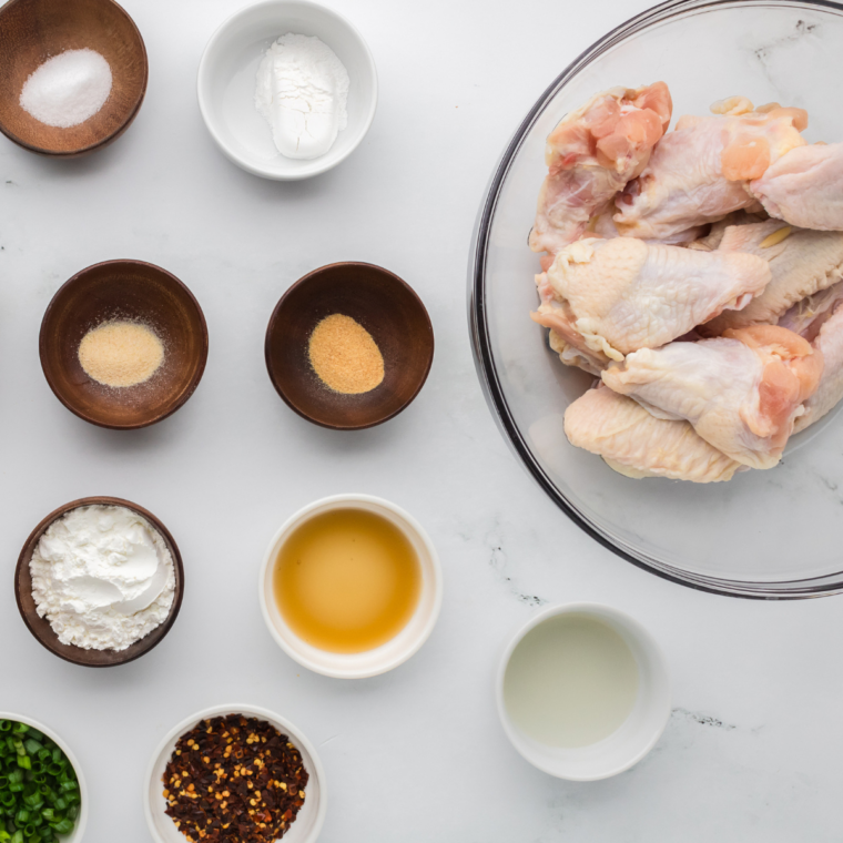 Ingredients for copycat Pizza Hut sweet chili wings, including chicken wings, baking powder, seasonings, and sweet chili sauce.