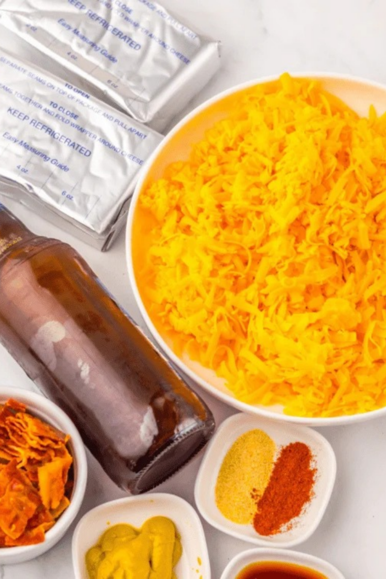 Ingredients for Wisconsin cheddar cheese sauce, including shredded sharp cheddar, American cheese, butter, flour, milk, and evaporated milk