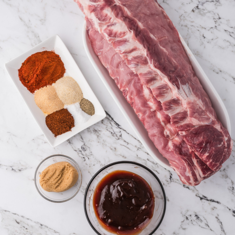 Ingredients for homemade Kansas City BBQ sauce: ketchup, molasses, brown sugar, vinegar, and spices on a kitchen counter