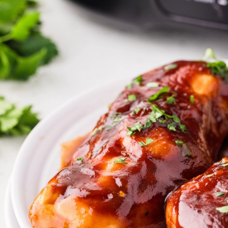 Juicy BBQ chicken thighs glazed with sweet and tangy Kansas City BBQ sauce