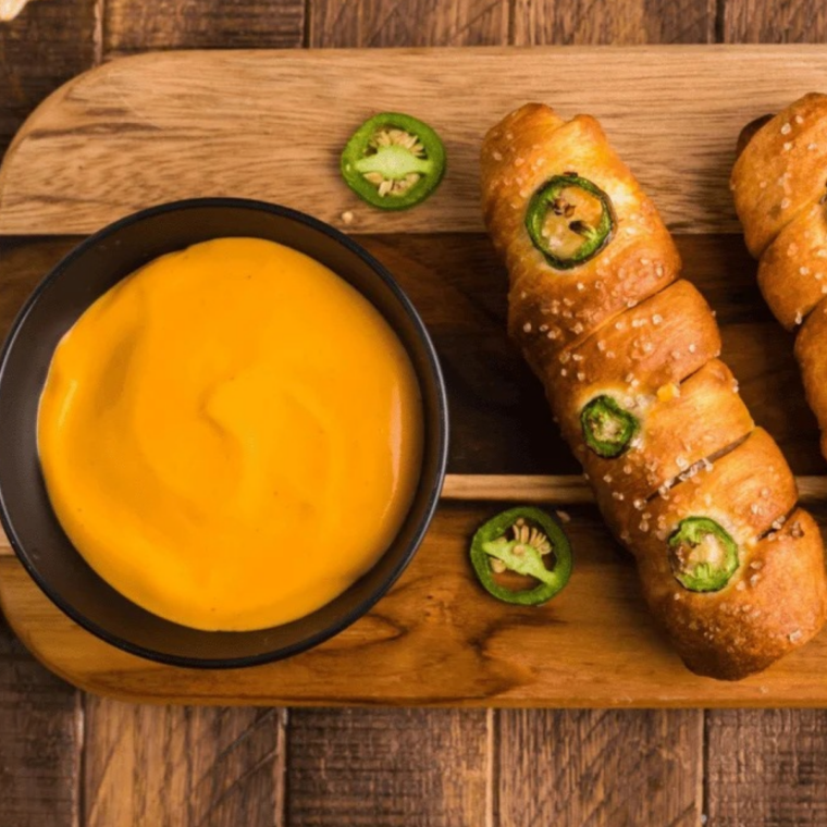 Crispy fry dipped into homemade Wisconsin cheddar cheese sauce