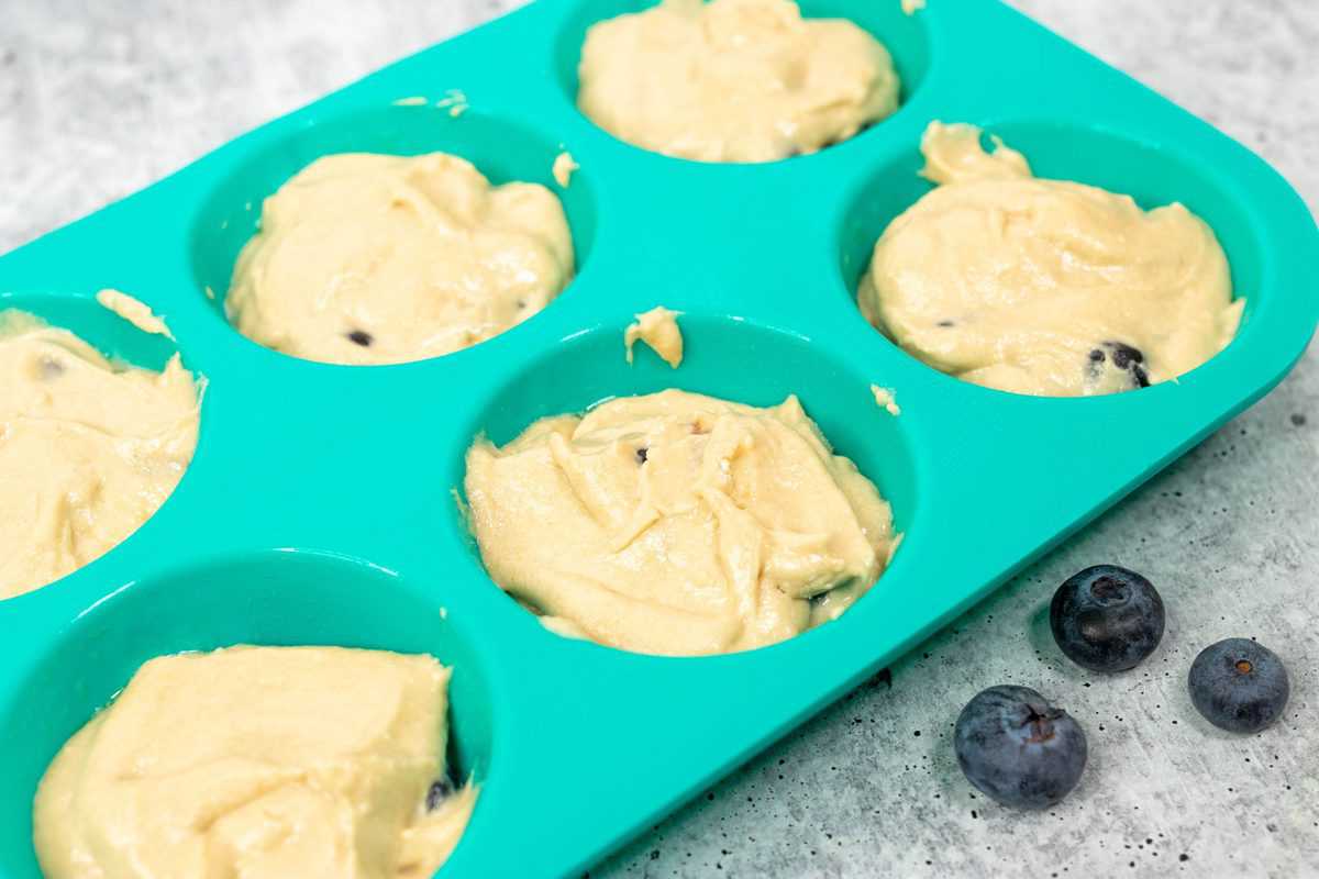air fryer blueberry muffin batter in a silicone muffin tin