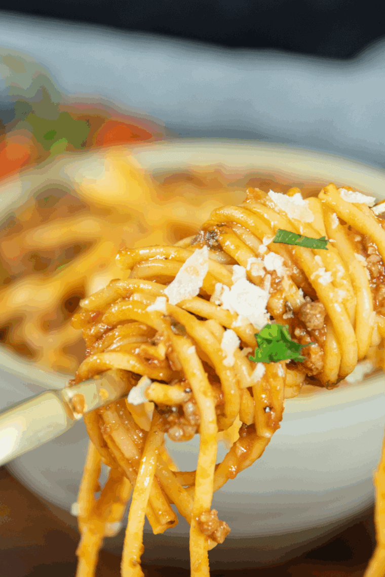 Hearty Old Spaghetti Factory-style meat sauce served over spaghetti noodles with fresh herbs.