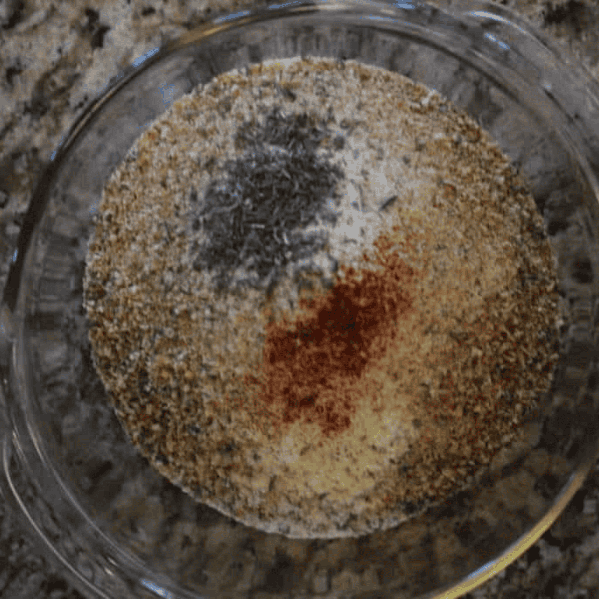 Mixing all of the seasonings in a large clear mixing bowl.