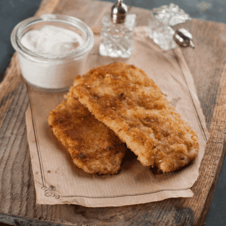 Cooked pork chops on a cutting board, after being cooked with homemade Shake and Bake Copycat.