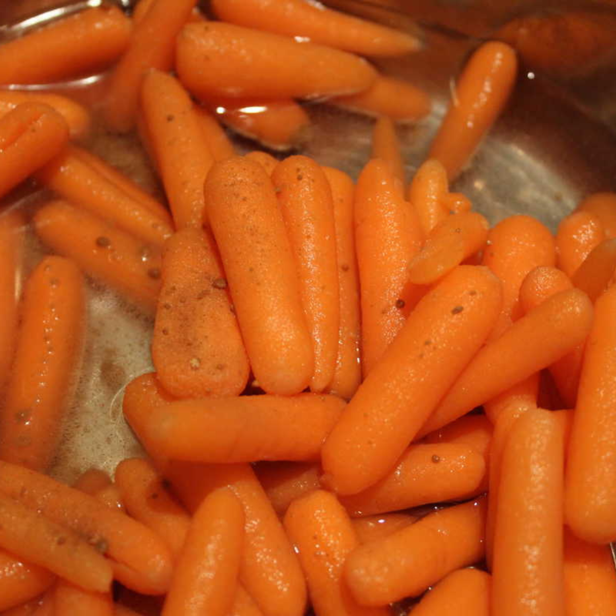 Place the carrots in the Instant Pot. Add the honey, ginger, butter, salt, and pepper. Stir well to coat the carrots evenly.