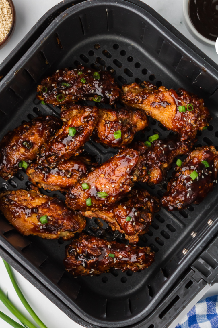 Close-up of air-fried Chinese-style wings glazed with a savory soy and ginger sauce.