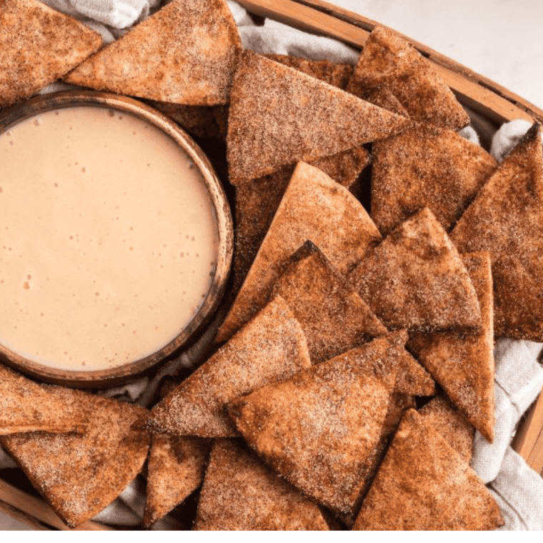 A plate of crispy, golden air fryer cinnamon tortilla chips dusted with cinnamon sugar, ready to enjoy.