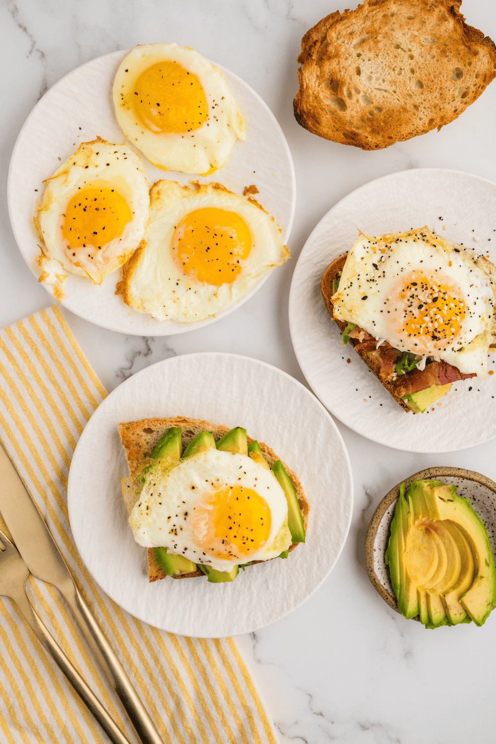 Perfectly cooked air fryer fried eggs with crispy edges and runny yolk.