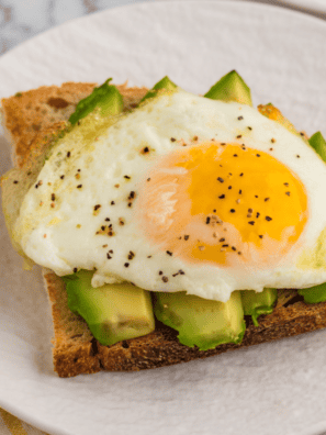 Perfectly cooked air fryer fried eggs with crispy edges and soft yolks."