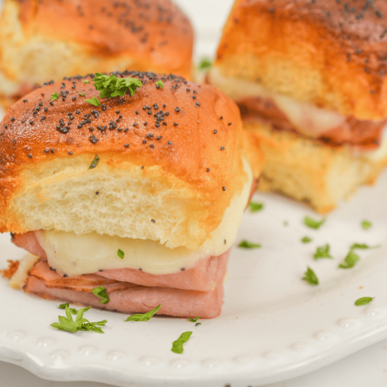 Golden air fryer King&rsquo;s Hawaiian ham and cheese sliders with melted cheese and sliced ham on soft Hawaiian rolls.
