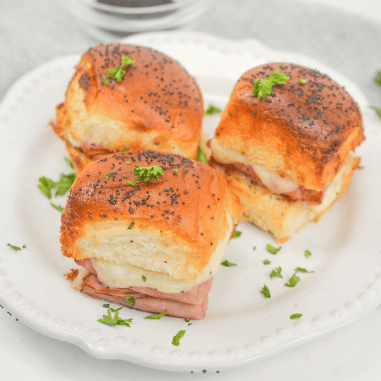 Cheesy ham and cheese sliders on King&rsquo;s Hawaiian rolls cooked in the air fryer until warm, buttery, and golden brown.