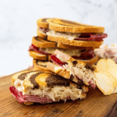 "Delicious Air Fryer Reuben sandwich stacked with corned beef, sauerkraut, Swiss cheese, and Russian dressing."