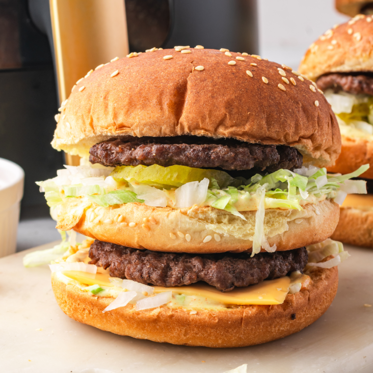  Homemade Big Mac with two beef patties, special sauce, lettuce, cheese, pickles, and onions on a sesame seed bun.