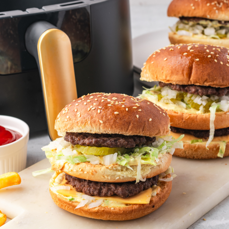 Homemade Big Mac with special sauce, beef patties, lettuce, pickles, onions, and sesame seed buns.