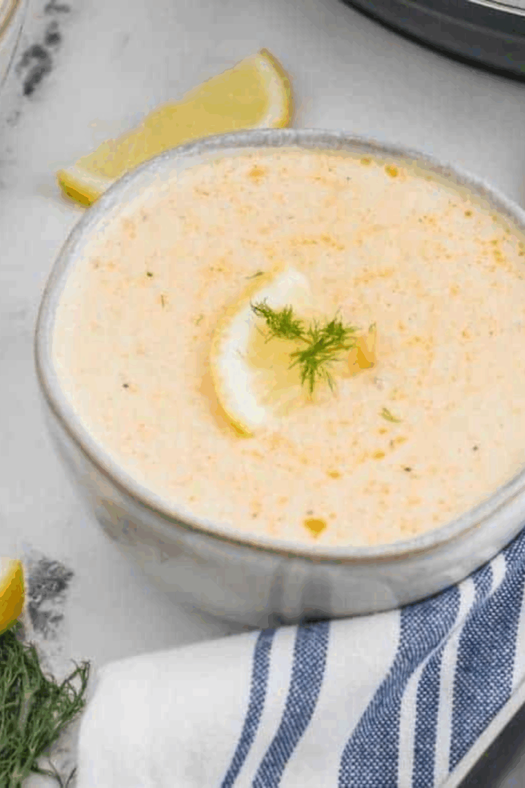 Creamy South Carolina she-crab soup served in a bowl, garnished with crab meat and fresh herbs