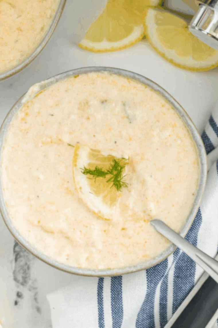 Creamy South Carolina she-crab soup served in a bowl, garnished with crab meat and fresh herbs
