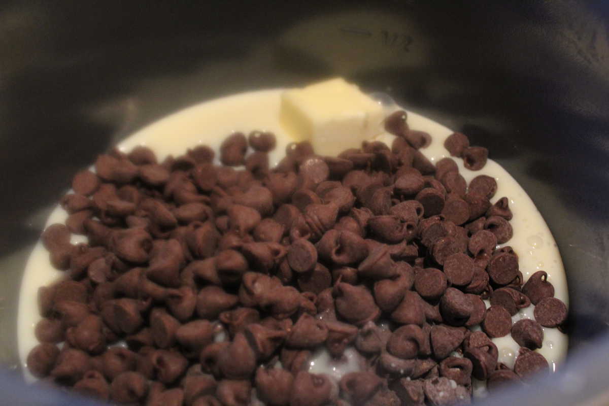 Chocolate chips with milk and butter in a bowl. 