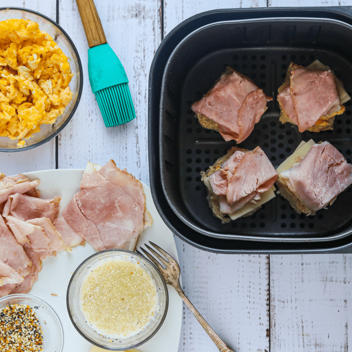 Air Fryer Ham and Cheese Sliders  in air fryer basket.