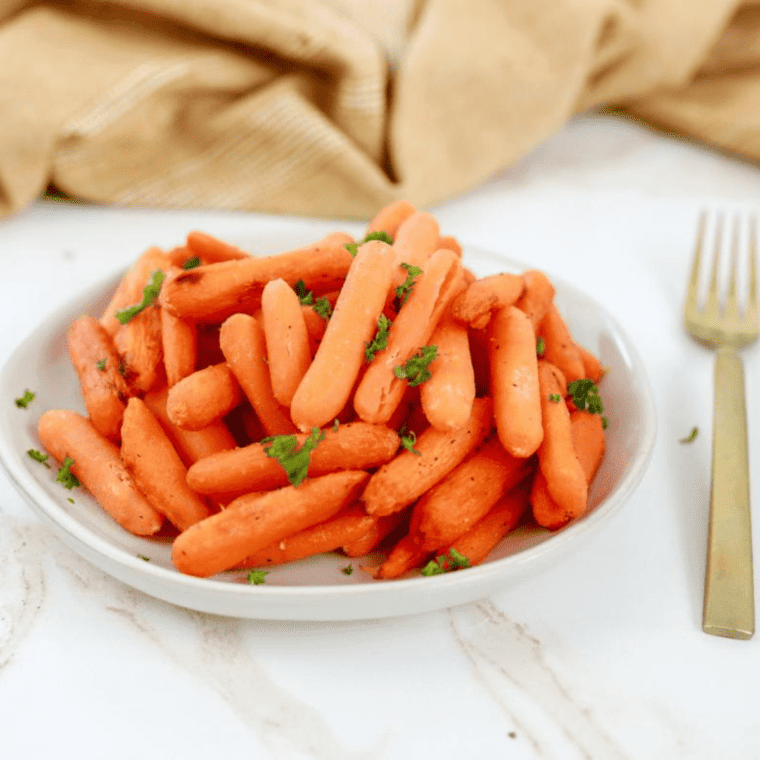 a plate of air fryer glazed carrots with herbs