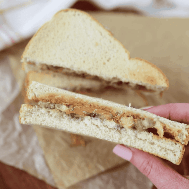 Air Fryer Peanut Butter and Banana Sandwich with golden crispy bread, melted peanut butter, and banana slices inside.