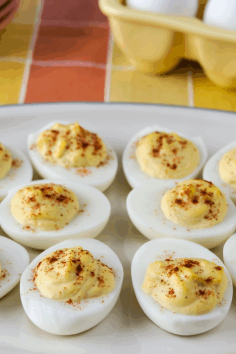Perfectly cooked Southern deviled eggs made in the air fryer, topped with paprika and served on a platter.