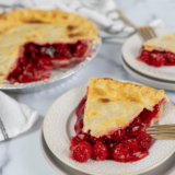 "Golden, flaky whole cherry pie made in the air fryer, topped with a lattice crust and filled with sweet cherry filling."