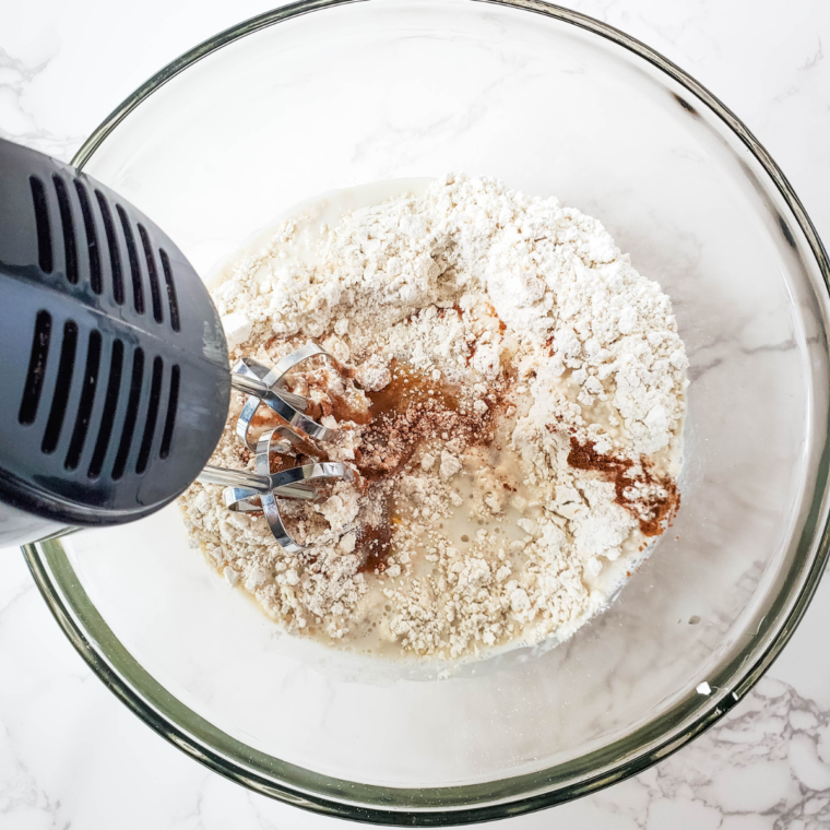 Mixing Bisquick, brown sugar, butter, and cinnamon for coffee cake topping, creating a crumbly texture.