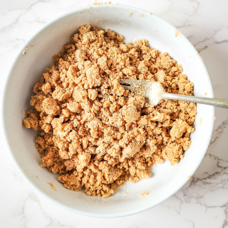 Mixing Bisquick, brown sugar, butter, and cinnamon for a crumbly coffee cake topping, swirling into the batter with a knife.