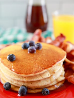 Fluffy air fryer pancakes stacked with butter and syrup on top