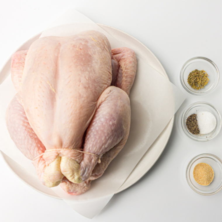 Preparing the Chicken: Rinsing the whole chicken under cold water and patting it dry with paper towels.