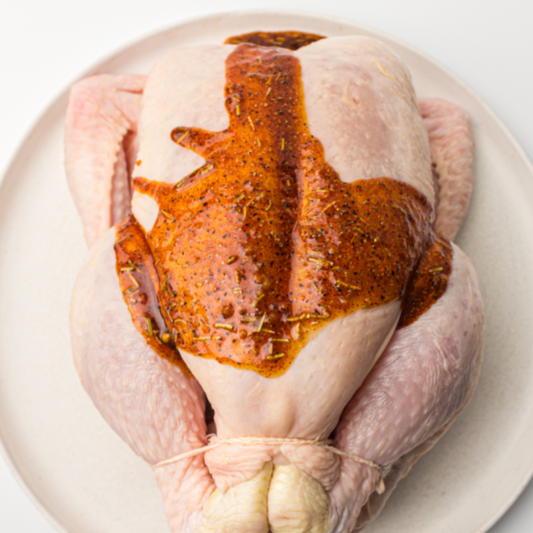 Seasoning the Chicken: Sprinkling salt, pepper, lemon zest, and thyme over the chicken, ensuring even coverage