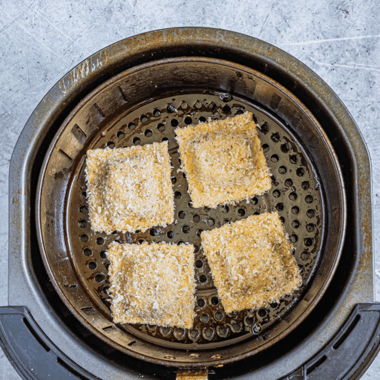 Placing ravioli in a single layer on parchment-lined baking sheet or air fryer basket