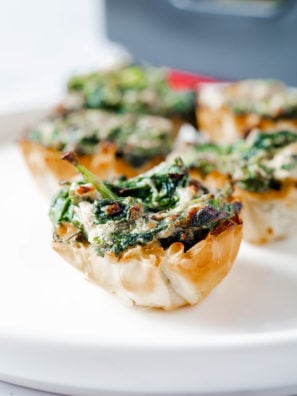 ere are some delicious recipe variations for Air Fryer Spanakopita Phyllo Cups: Mushroom and Feta: Add sautéed mushrooms to the spinach and ricotta filling mixture for an earthy flavor boost. Mix in crumbled feta cheese for a tangy and savory addition that pairs perfectly with the mushrooms. Sun-Dried Tomato and Olive: Incorporate chopped sun-dried tomatoes and sliced Kalamata olives into the filling mixture for a Mediterranean twist. The sweet-tartness of the tomatoes and brininess of the olives add depth of flavor to the Spanakopita Phyllo Cups. Spinach and Artichoke: Combine chopped artichoke hearts with the spinach and ricotta filling for a creamy and indulgent variation. The artichokes add a subtle sweetness and a hint of tanginess that complements the other ingredients beautifully. Greek-Inspired Seasonings: Enhance the flavor of the filling by adding Greek-inspired seasonings such as dried oregano, basil, and a pinch of nutmeg. These aromatic spices elevate the taste of the Spanakopita Phyllo Cups with their vibrant and herbaceous notes. Spicy Spinach and Feta: For a kick of heat, mix finely chopped jalapeños or crushed red pepper flakes into the filling mixture. The spicy kick adds an exciting twist to the traditional Spanakopita Phyllo Cups, perfect for those who enjoy a bit of heat in their appetizers. Feel free to experiment with these recipe variations to create your perfect Air Fryer Spanakopita Phyllo Cups, customizing the ingredients to suit your taste preferences and dietary needs!